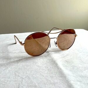 Gold tone pink lens round sunglasses with brow bar